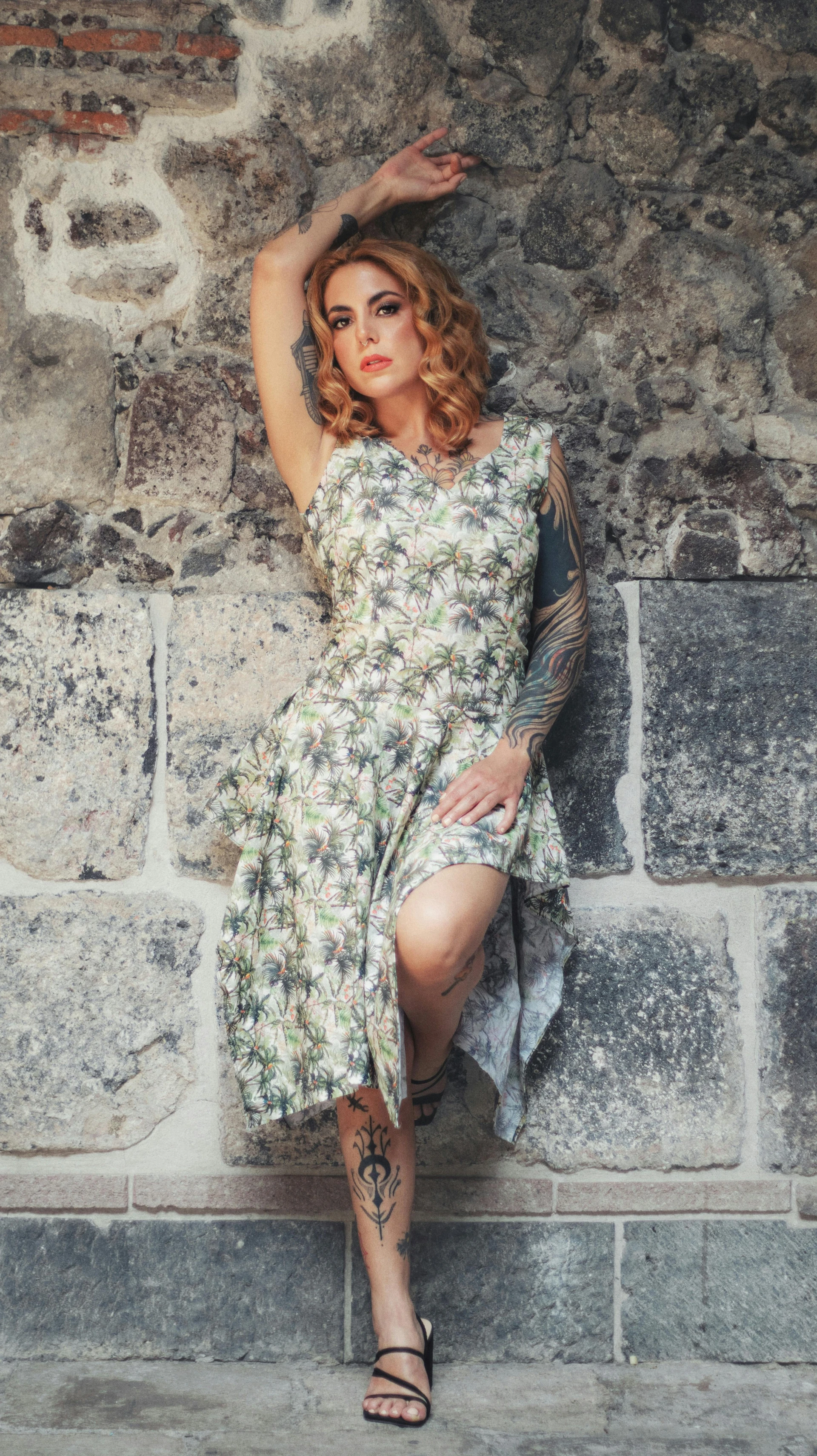 Lighting setup for white palm tree dress against stone wall