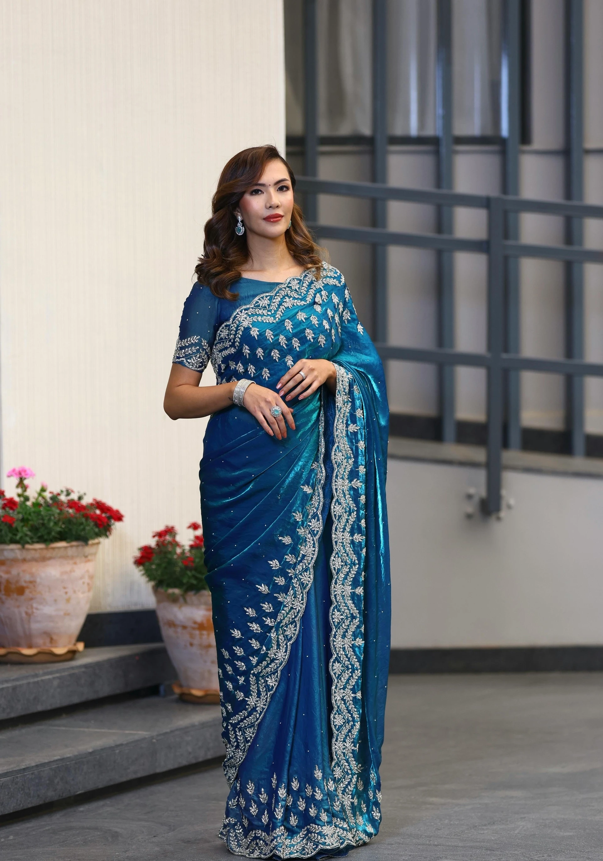 Will heavy teal embroidered saree make me look wider at wedding?